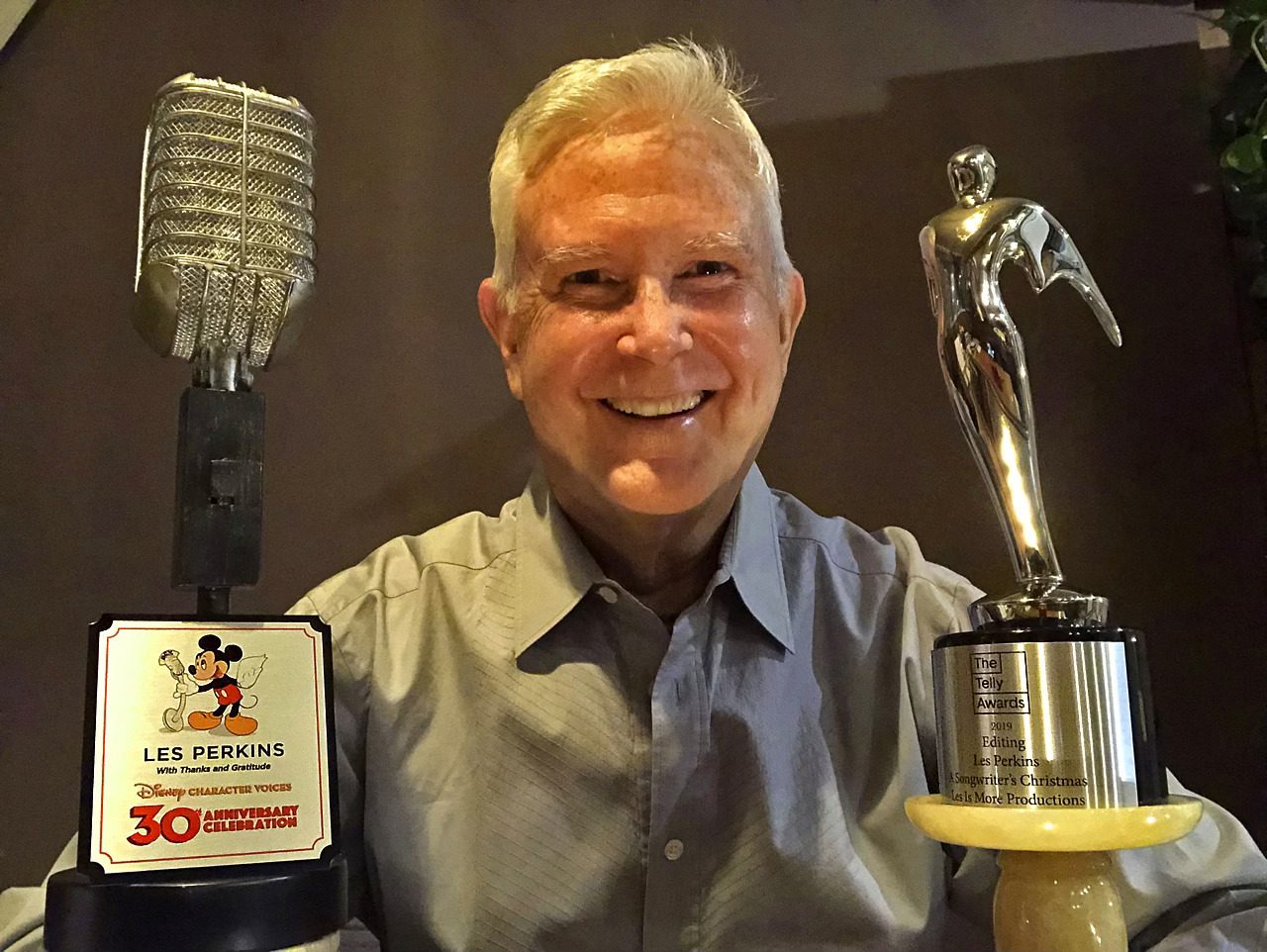 Person with microphone and statue trophies